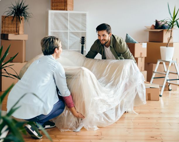 Couple unboxing furniture in living room